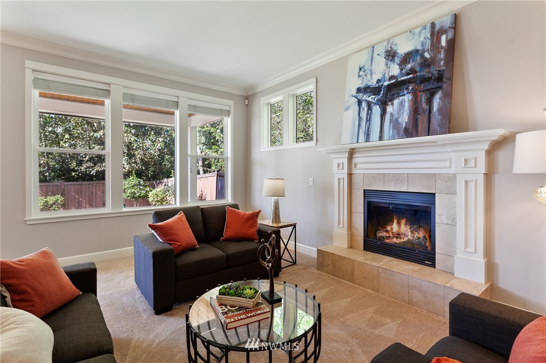 718 South 36th Place Renton, WA 98055 - Photo 9 of 40 a living room with furniture and a fireplace
