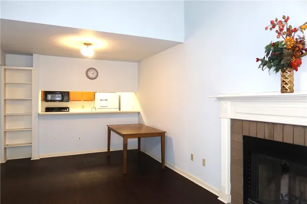 a view of a room with a fireplace and potted plant