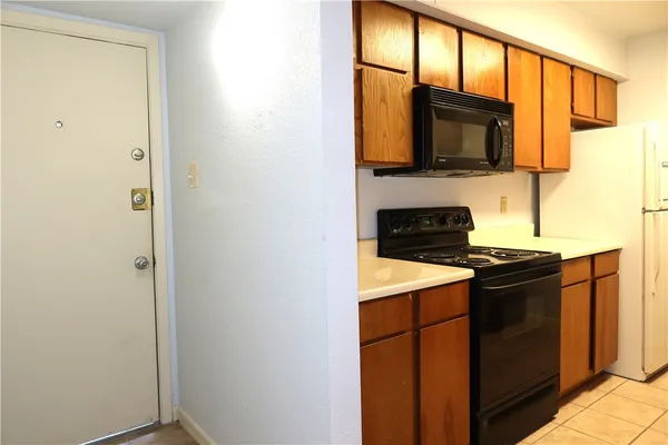 a kitchen with stainless steel appliances a stove microwave and a sink