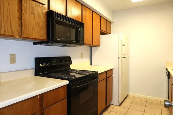 a kitchen with stainless steel appliances a stove microwave and refrigerator