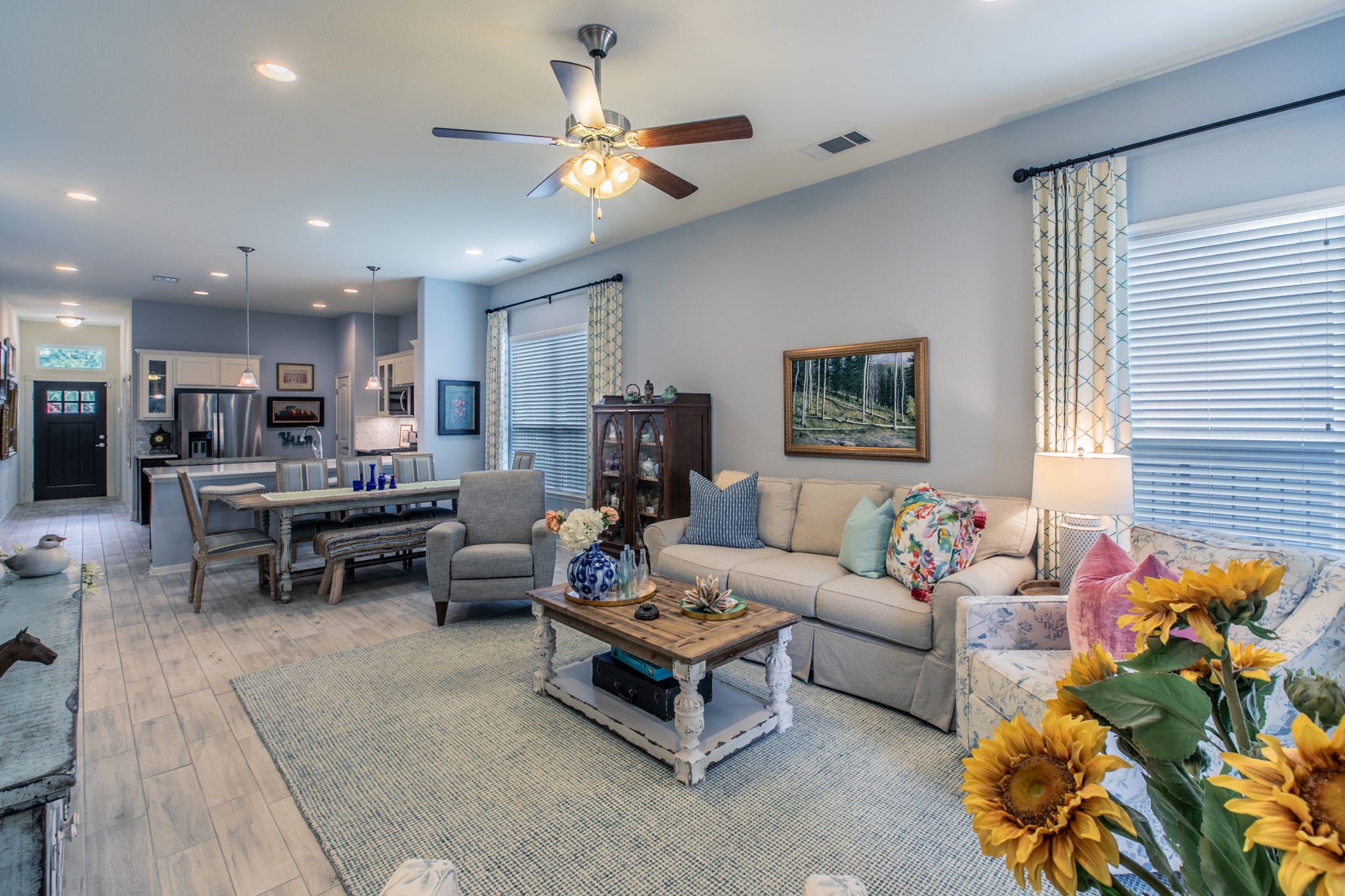 231 Simon Kyle, TX 78640 - Photo 8 of 29 Open-concept living area featuring light wood-finish flooring, recessed lighting, and a ceiling fan with integrated lighting