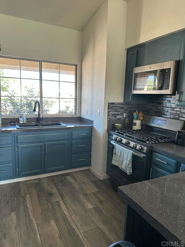 952 Alameda Street Calexico, CA 92231 - Photo 5 of 7 a kitchen with stainless steel appliances granite countertop a stove a sink and a microwave