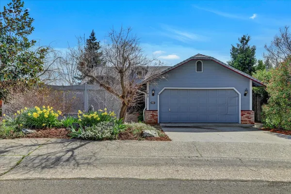 a front view of a house with a yard and a garage