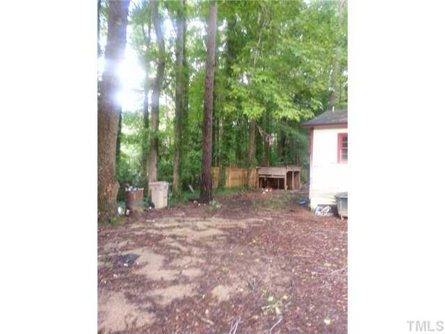 1503 Axum Road Garner, NC 27529 - Photo 3 of 3 a view of a backyard with plants and large trees
