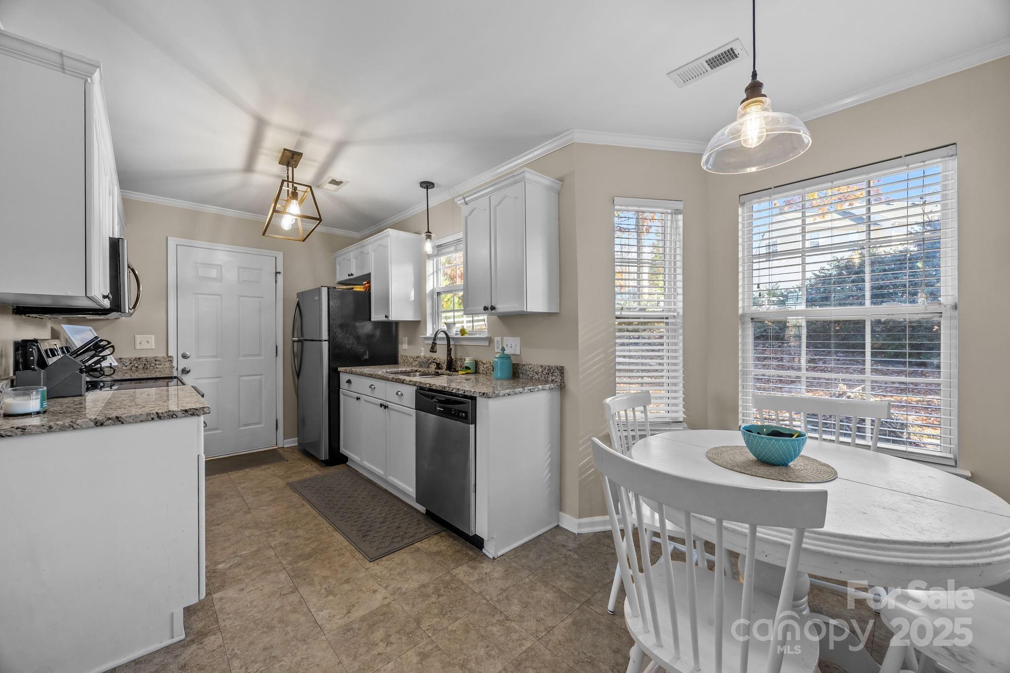 135 Shade Tree Circle Fort Mill, SC 29715 - Photo 11 of 34 a kitchen with stainless steel appliances granite countertop a stove a sink a refrigerator and a refrigerator