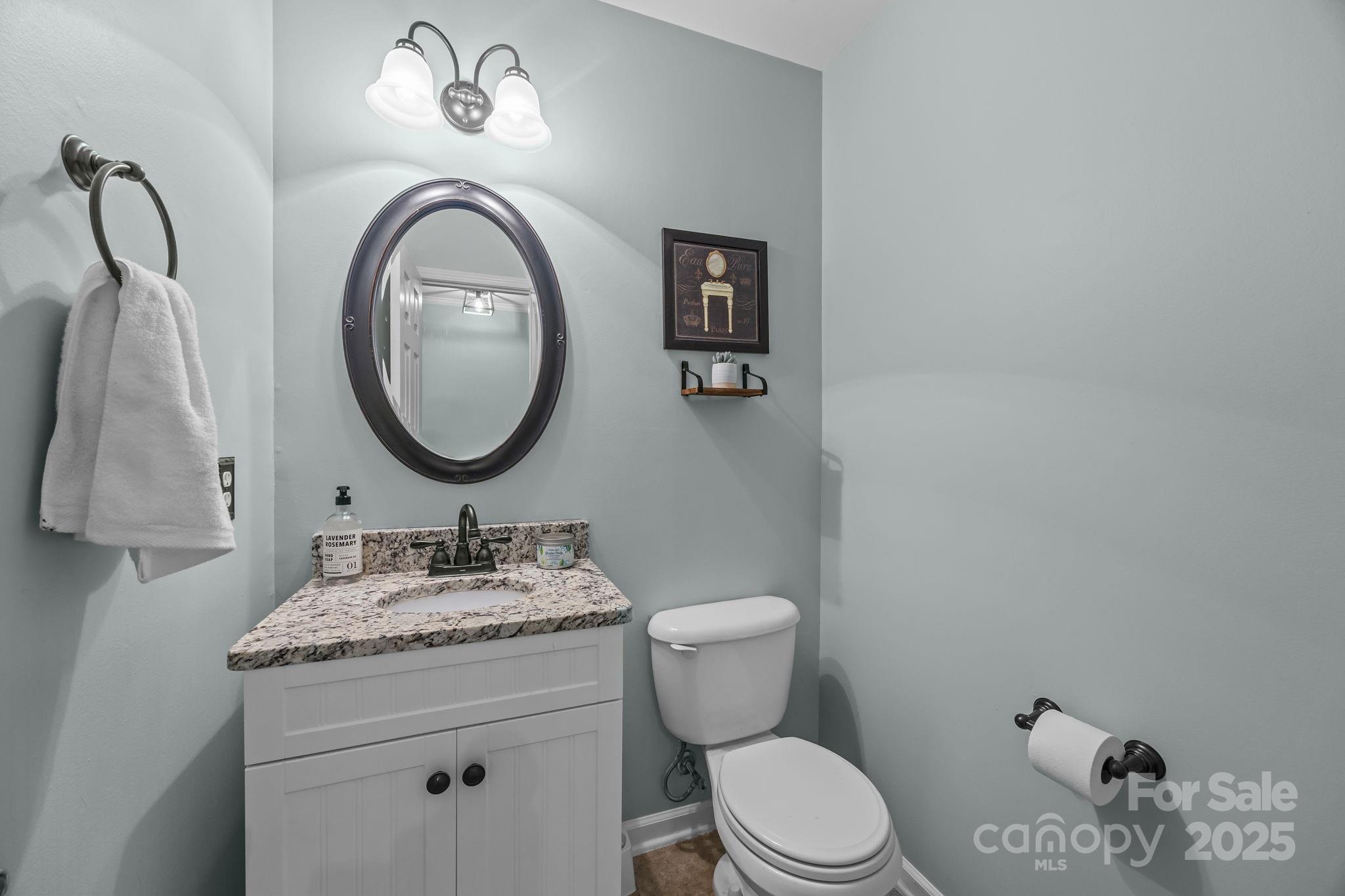 135 Shade Tree Circle Fort Mill, SC 29715 - Photo 12 of 34 a bathroom with a granite countertop toilet sink and mirror