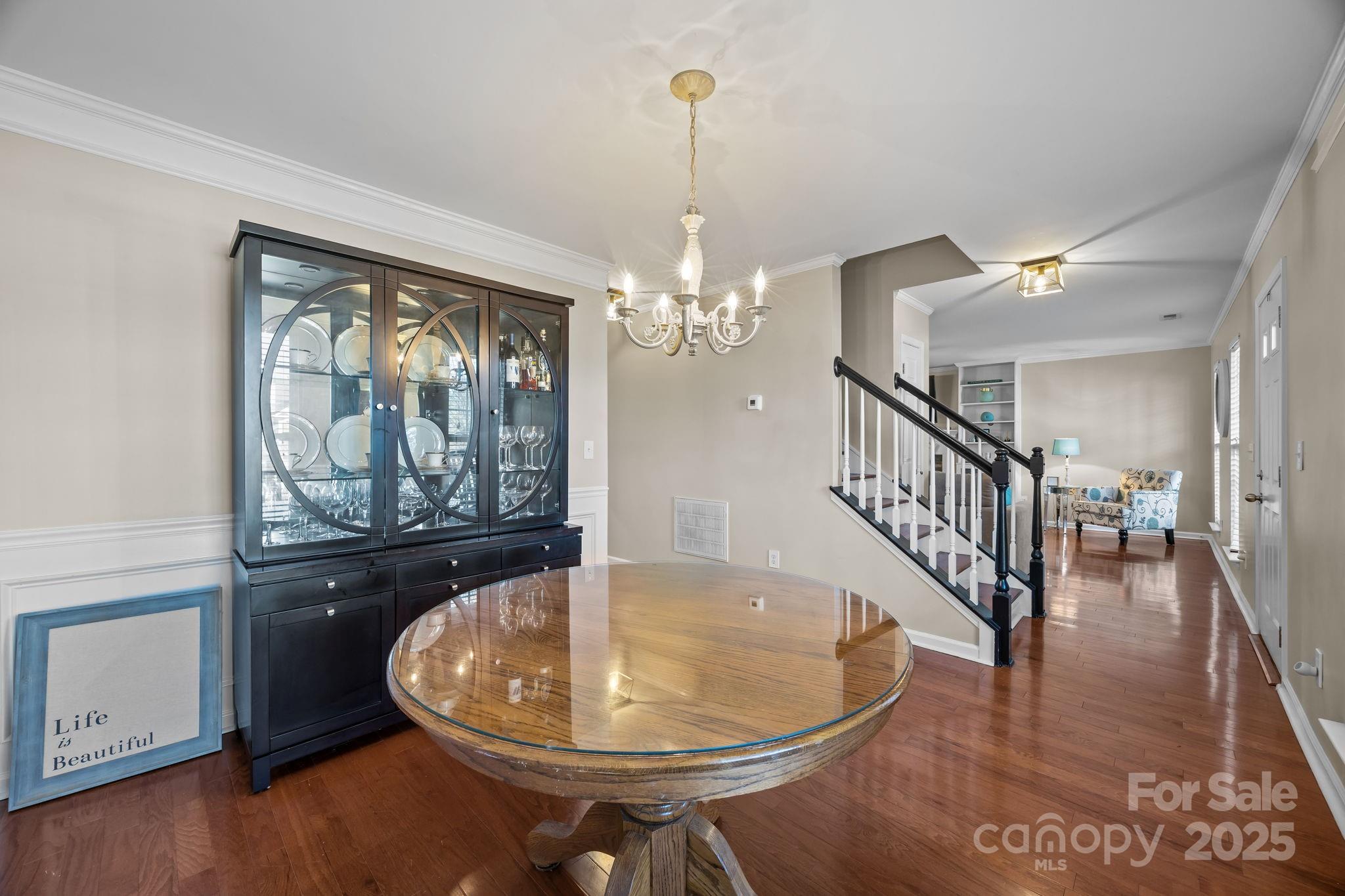 135 Shade Tree Circle Fort Mill, SC 29715 - Photo 14 of 34 a dining room with wooden floor a chandelier a wooden table and chairs