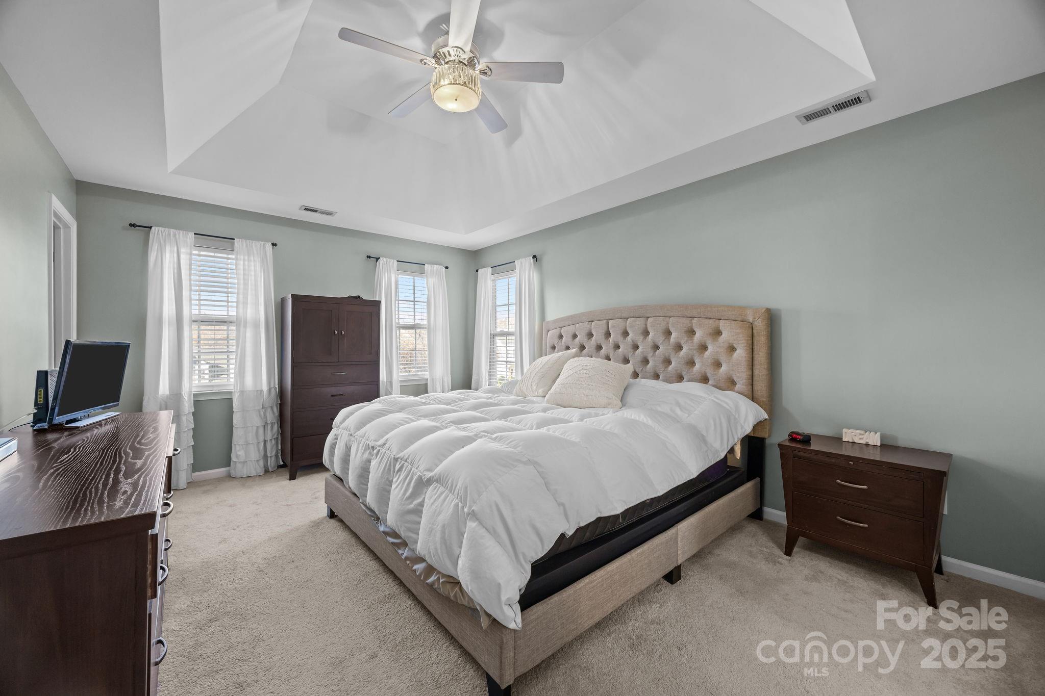 135 Shade Tree Circle Fort Mill, SC 29715 - Photo 15 of 34 a spacious bedroom with a bed and a flat screen tv