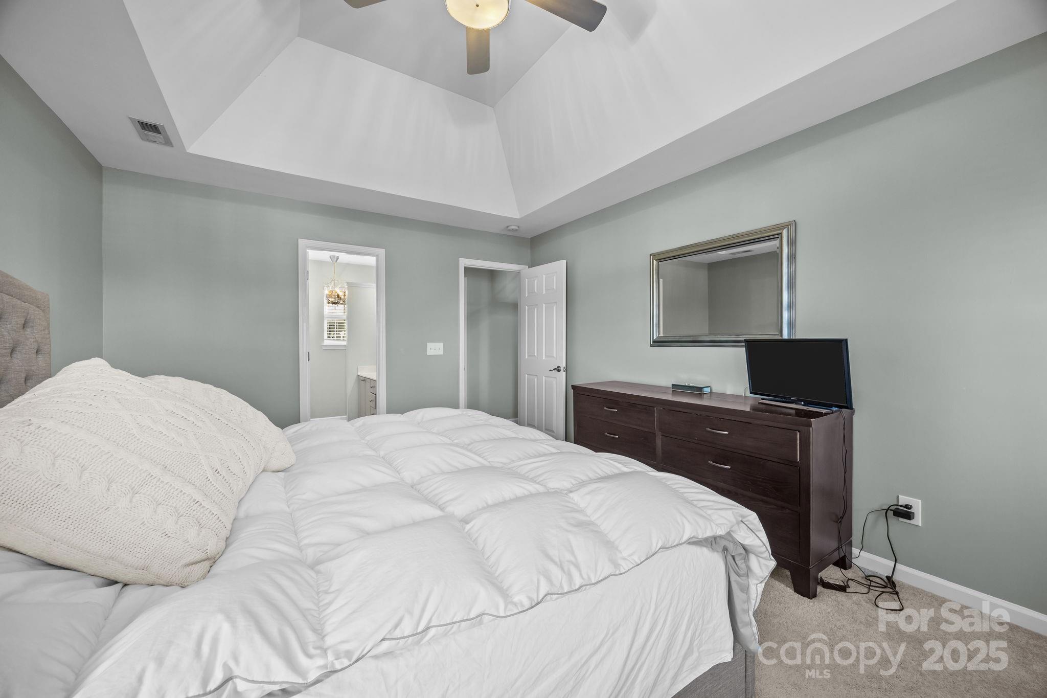 135 Shade Tree Circle Fort Mill, SC 29715 - Photo 16 of 34 a bedroom with a bed and a flat screen tv