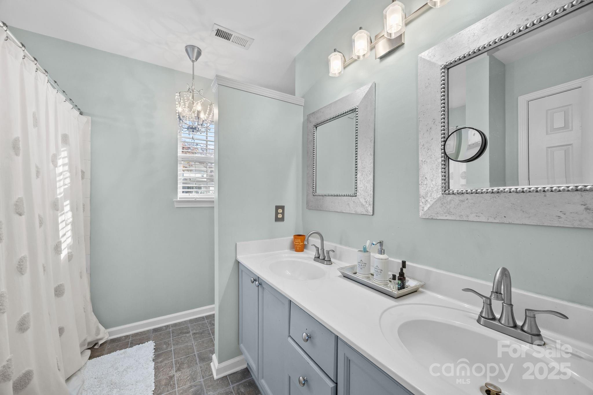 135 Shade Tree Circle Fort Mill, SC 29715 - Photo 17 of 34 a bathroom with a sink vanity granite and a mirror