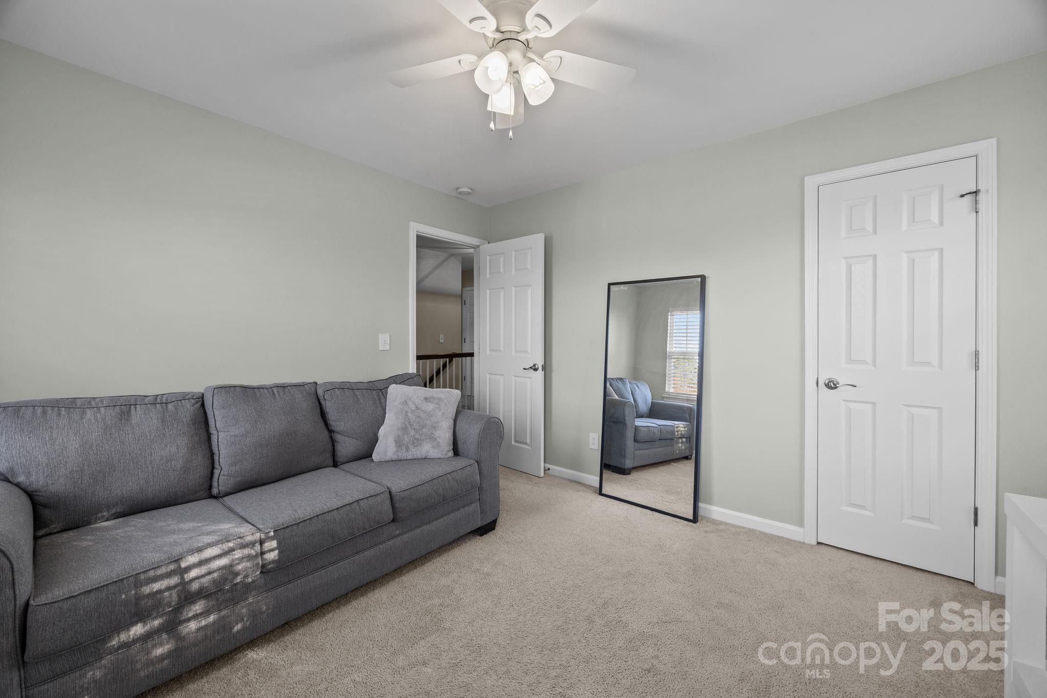 135 Shade Tree Circle Fort Mill, SC 29715 - Photo 22 of 34 a living room with furniture and a chandelier