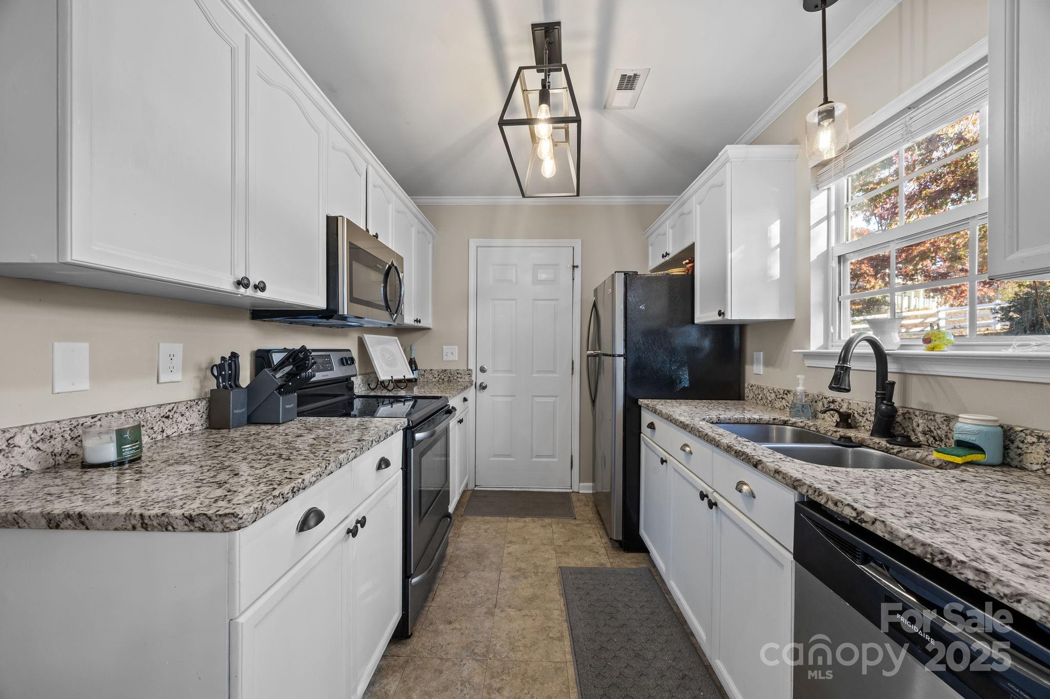 135 Shade Tree Circle Fort Mill, SC 29715 - Photo 8 of 34 a kitchen with stainless steel appliances granite countertop a sink stove and refrigerator