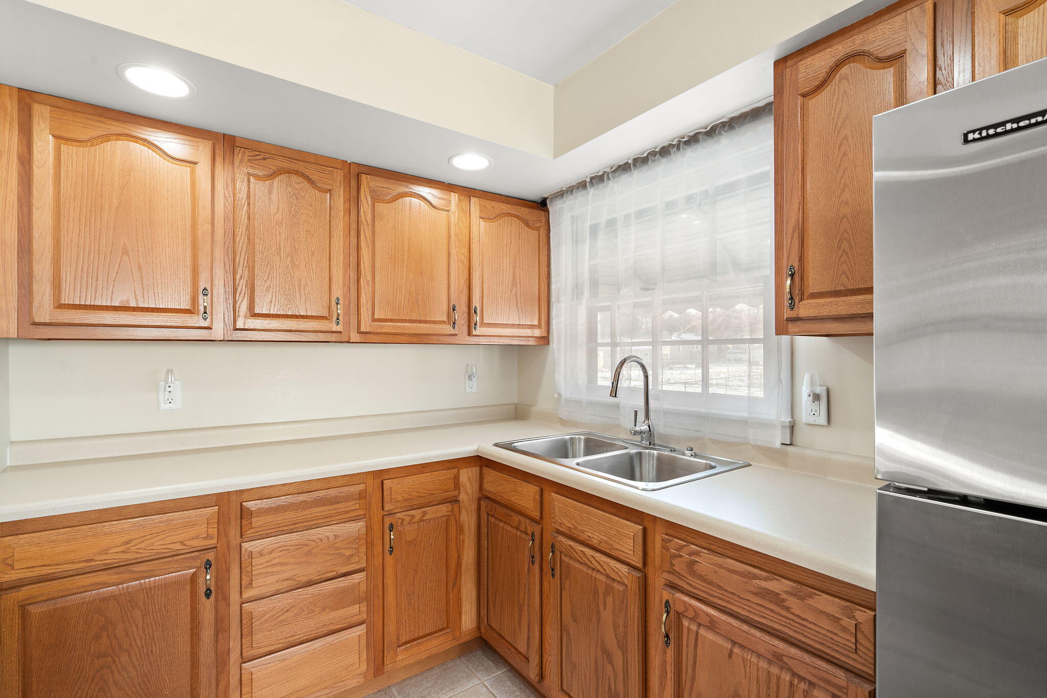 8228 Rutledge Street Merrillville, IN 46410 - Photo 11 of 32 a kitchen with stainless steel appliances granite countertop white cabinets and a sink