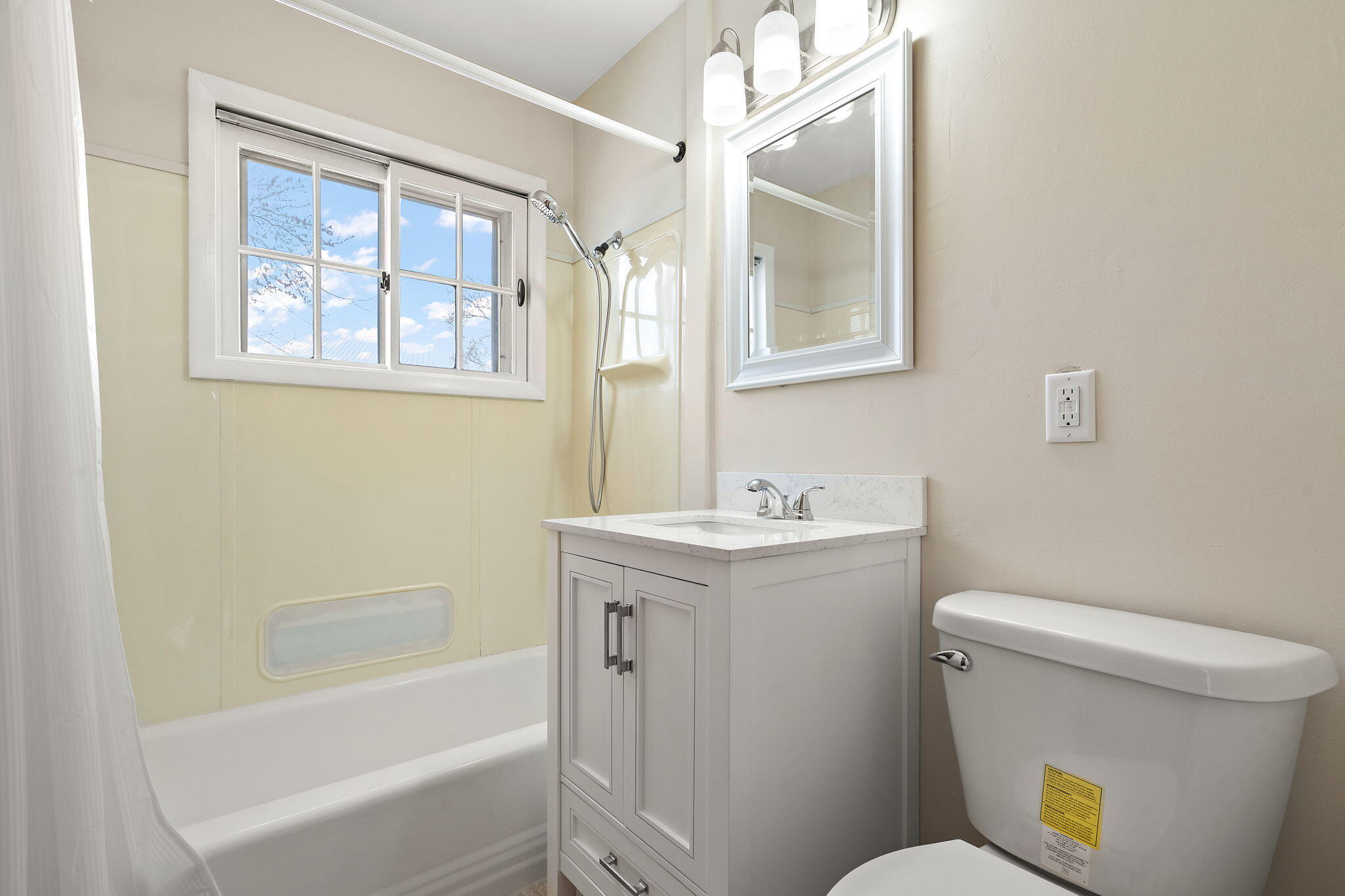 8228 Rutledge Street Merrillville, IN 46410 - Photo 14 of 32 a bathroom with a sink and mirror with toilet