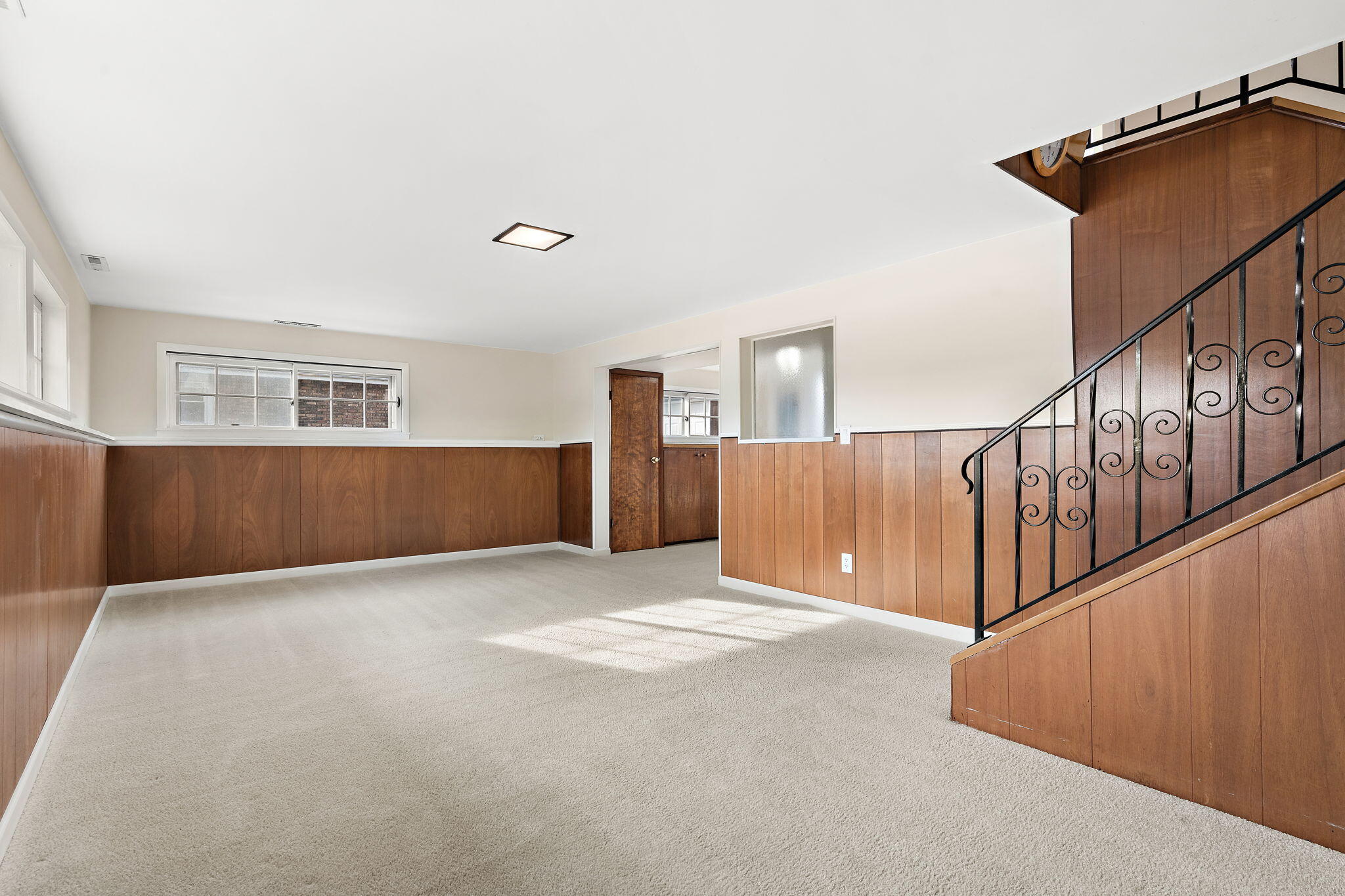 8228 Rutledge Street Merrillville, IN 46410 - Photo 20 of 32 a view of an empty room with wooden floor and stairs
