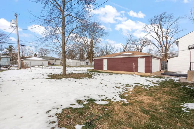 a view of a yard with snow on the road