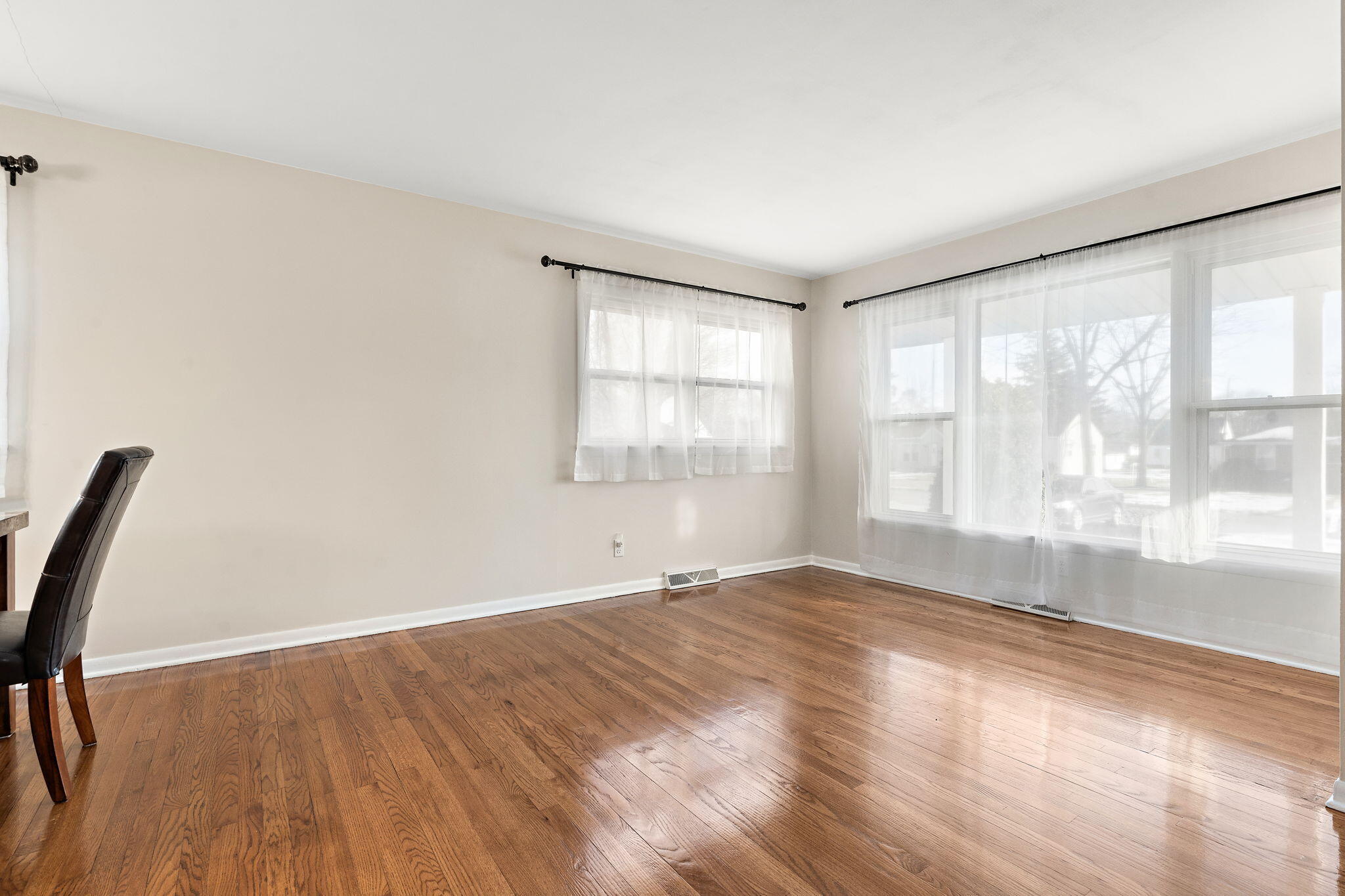 8228 Rutledge Street Merrillville, IN 46410 - Photo 6 of 32 a view of empty room with wooden floor and fan