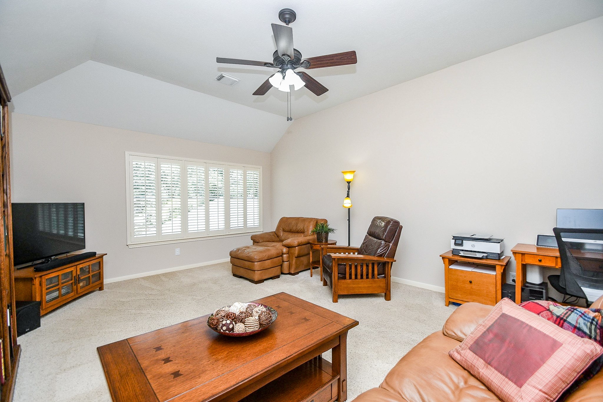 1703 Fall Ridge Circle Katy, TX 77494 - Photo 25 of 38 Expansive gameroom featuring oversized windows with a scenic view of mature trees, offering a versatile layout with ample space for large-scale furniture arrangements.