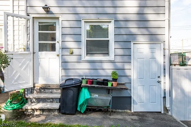 a front view of a house with a potted plant and a window