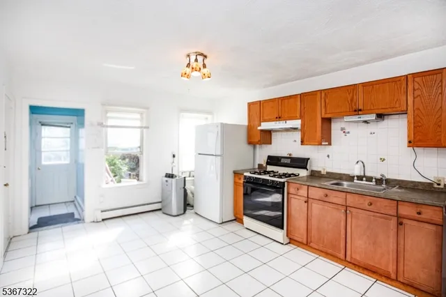 a kitchen with a sink cabinets and window