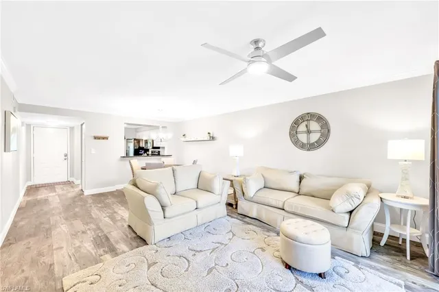 a living room with furniture and a clock