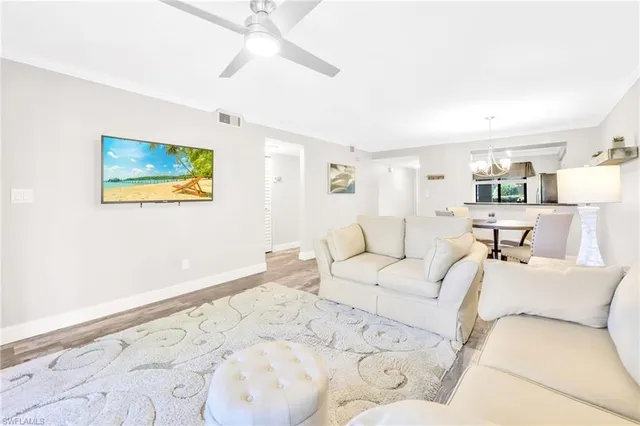 a living room with a bed and a painting on the wall