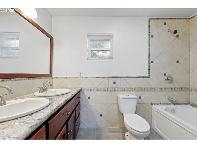 a kitchen with stainless steel appliances granite countertop a sink a stove a refrigerator a microwave oven with wooden floor