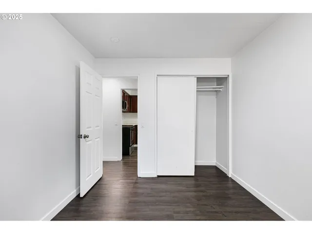a view of a yard with large tree and wooden fence