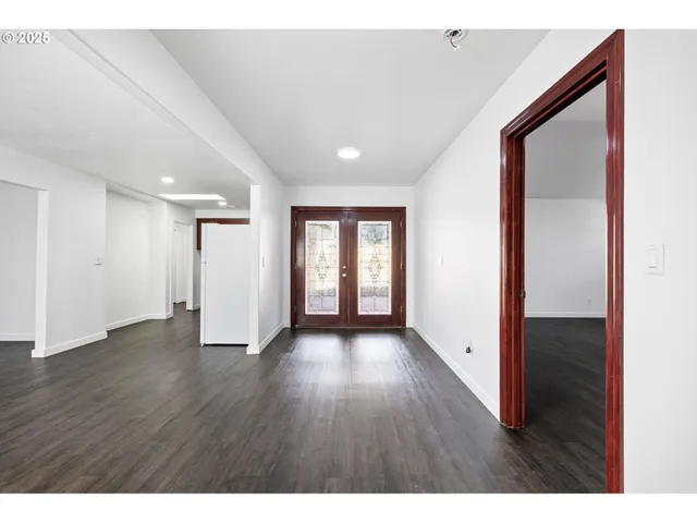 a view of an empty room and wooden floor
