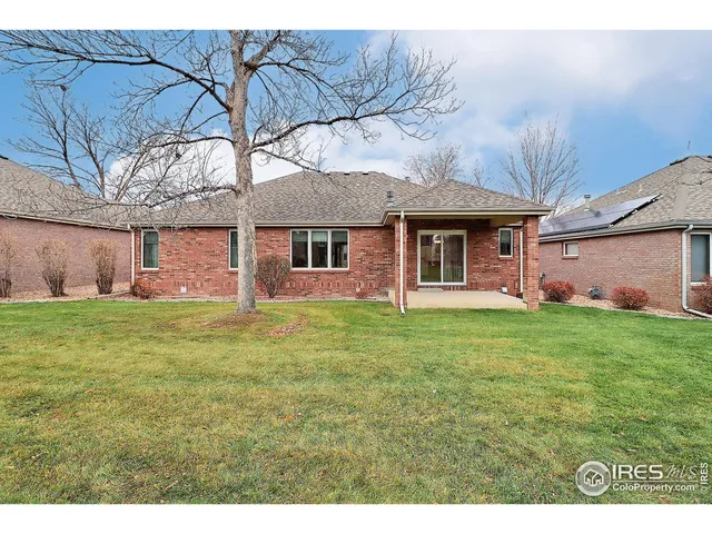 a view of a house with pool and a yard