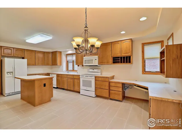 a kitchen with stainless steel appliances a sink and a refrigerator