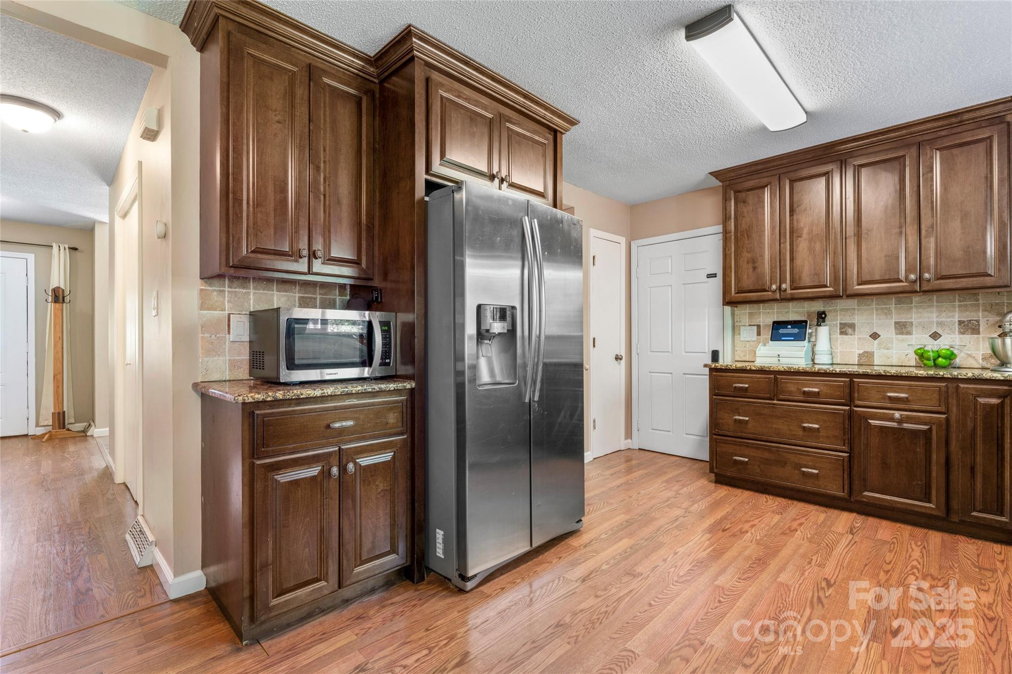 335 Bob White Run Salisbury, NC 28147 - Photo 12 of 41 a kitchen with stainless steel appliances granite countertop a refrigerator cabinets and wooden floor