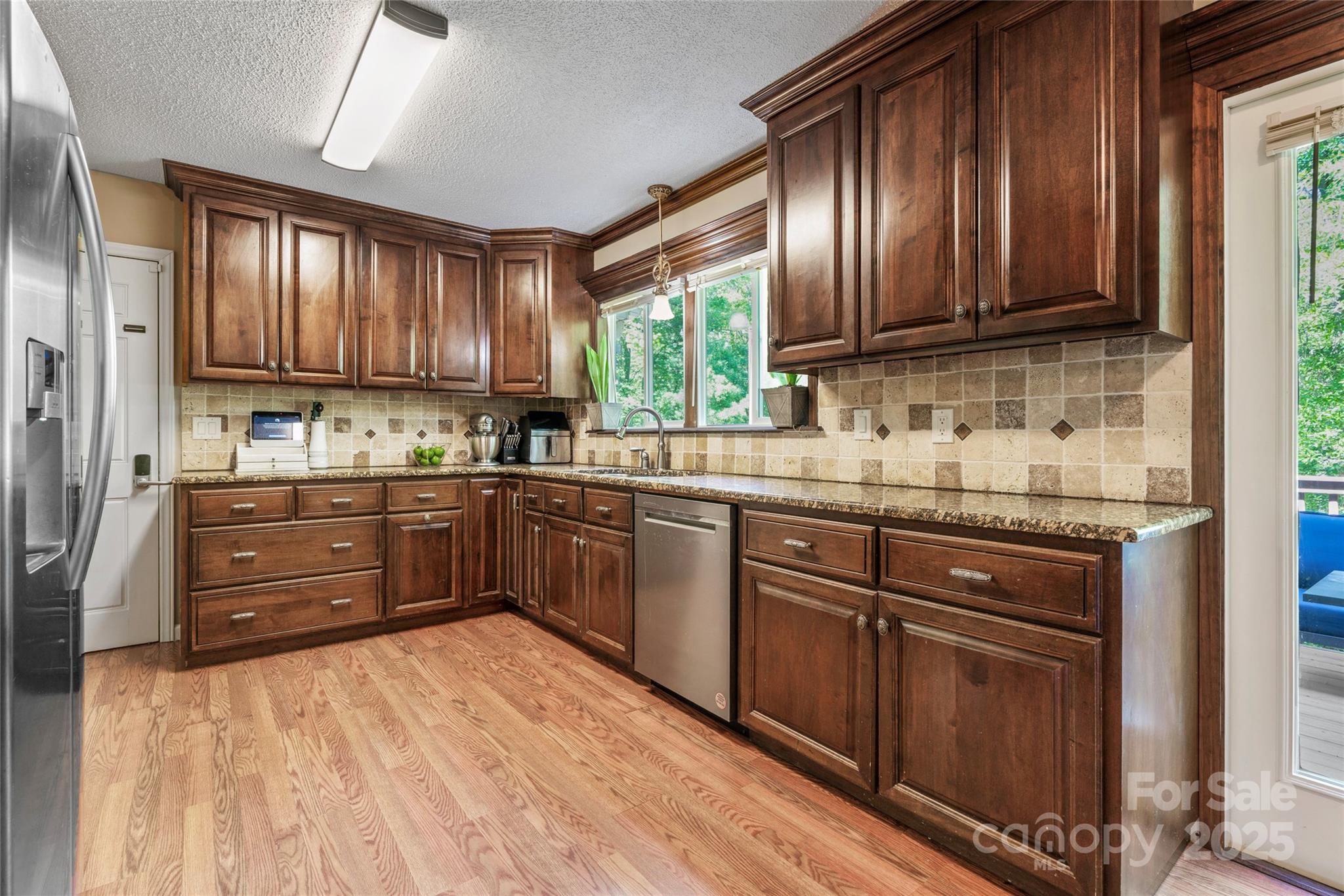 335 Bob White Run Salisbury, NC 28147 - Photo 13 of 41 a kitchen with stainless steel appliances granite countertop wooden cabinets a stove top oven a sink and dishwasher