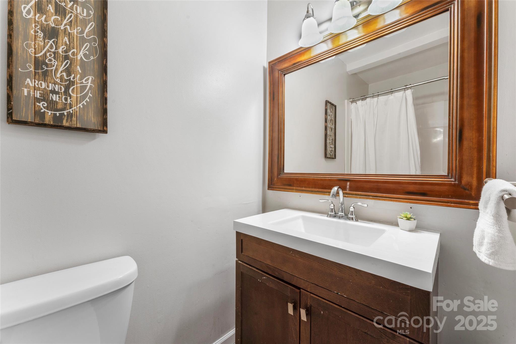 335 Bob White Run Salisbury, NC 28147 - Photo 26 of 41 a bathroom with a toilet sink and mirror