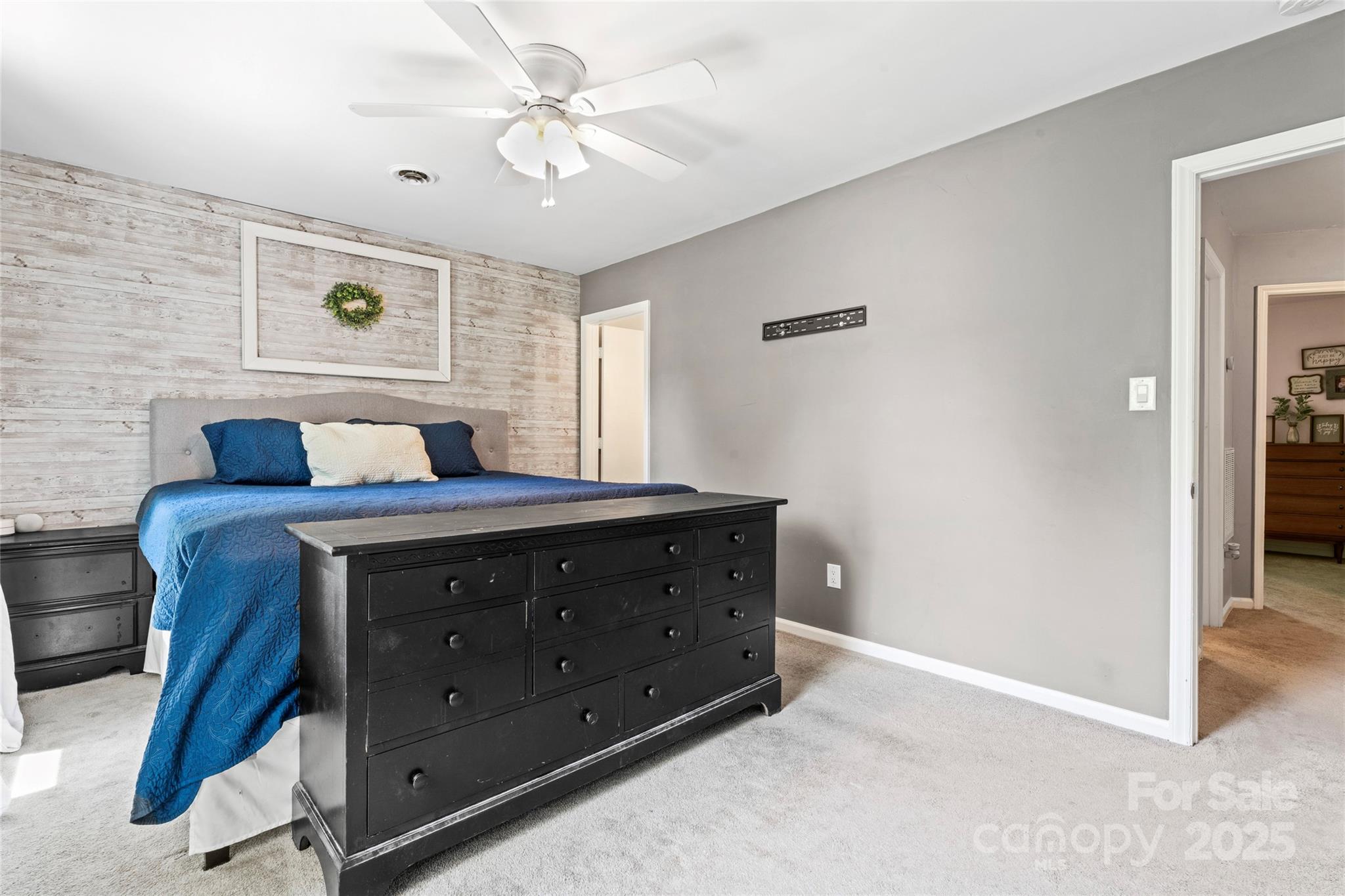 335 Bob White Run Salisbury, NC 28147 - Photo 28 of 41 a room with a bed and a chandelier