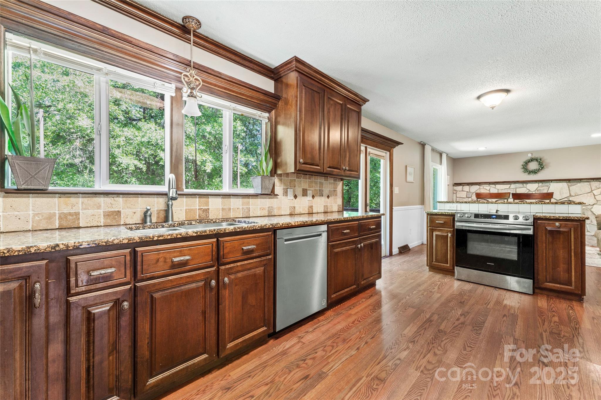 335 Bob White Run Salisbury, NC 28147 - Photo 10 of 41 a kitchen with granite countertop wooden floors appliances and sink