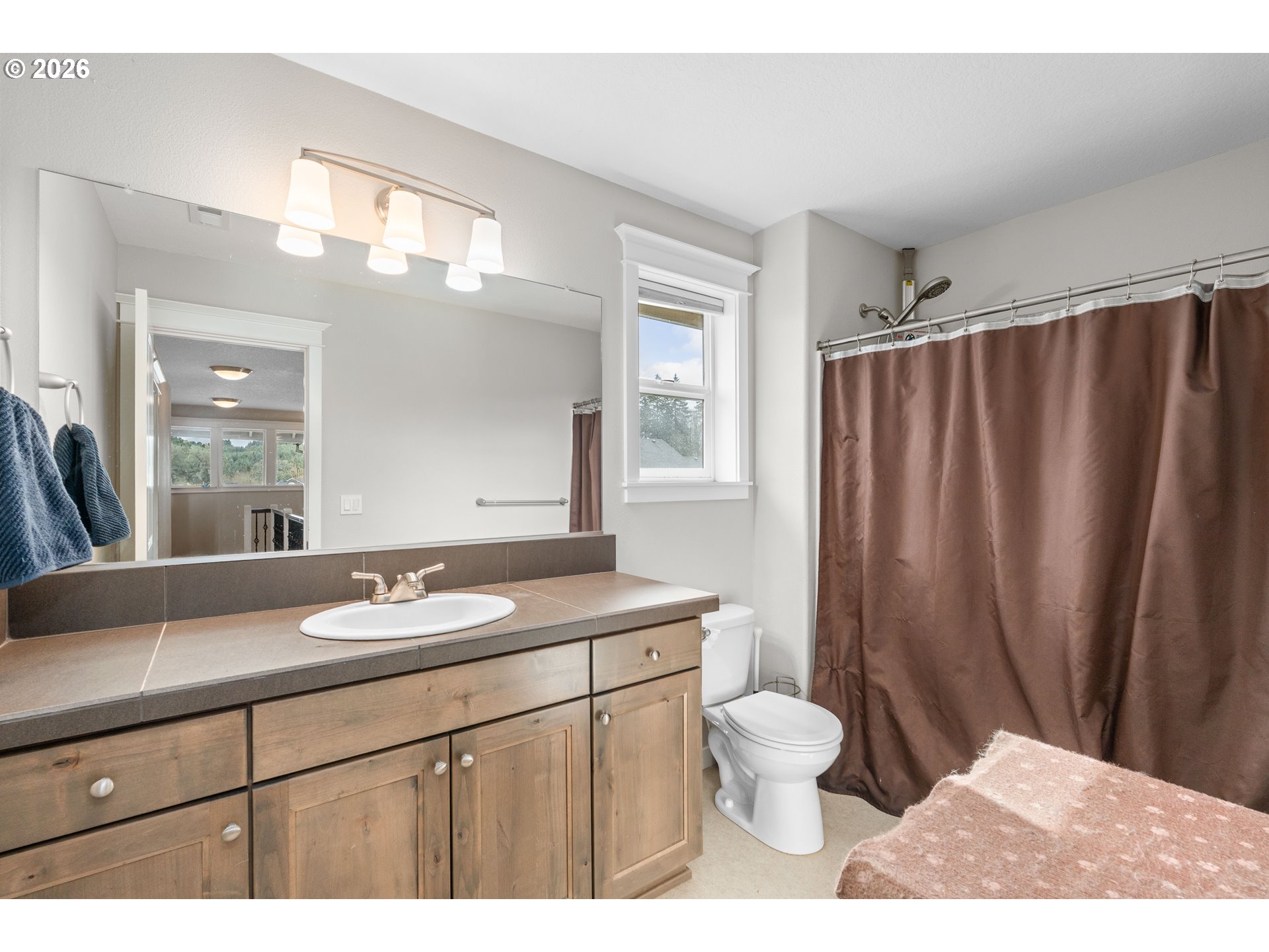2958 Southwest Redmond Hill Road McMinnville, OR 97128 - Photo 28 of 40 a bathroom with a sink a toilet and a mirror
