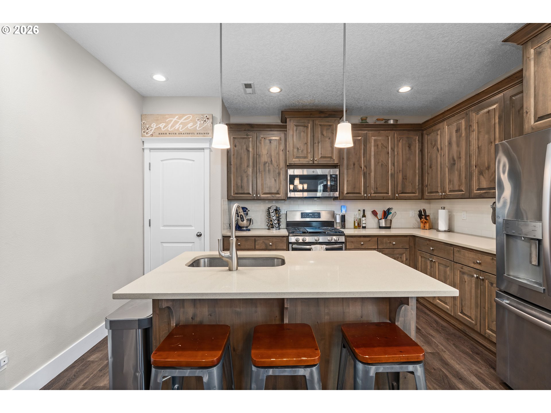 2958 Southwest Redmond Hill Road McMinnville, OR 97128 - Photo 7 of 40 a kitchen with kitchen island a sink cabinets and wooden floor