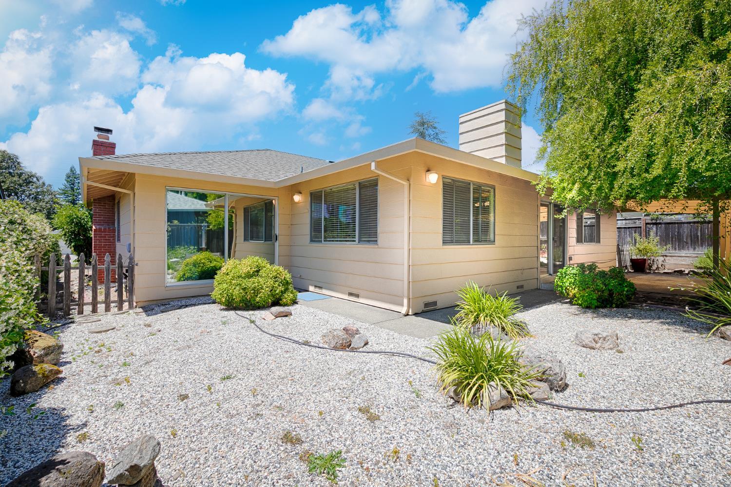 138 Oak Shadow Drive Santa Rosa, CA 95409 - Photo 45 of 50 a front view of a house with a yard and potted plants