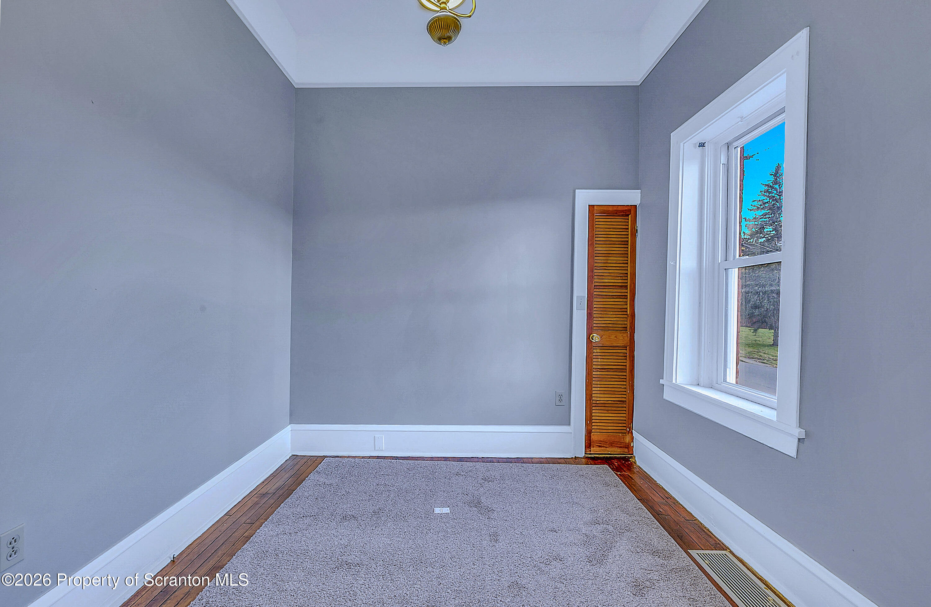 714 Smith Street Dunmore, PA 18512 - Photo 13 of 15 a view of an empty room with window and closet area