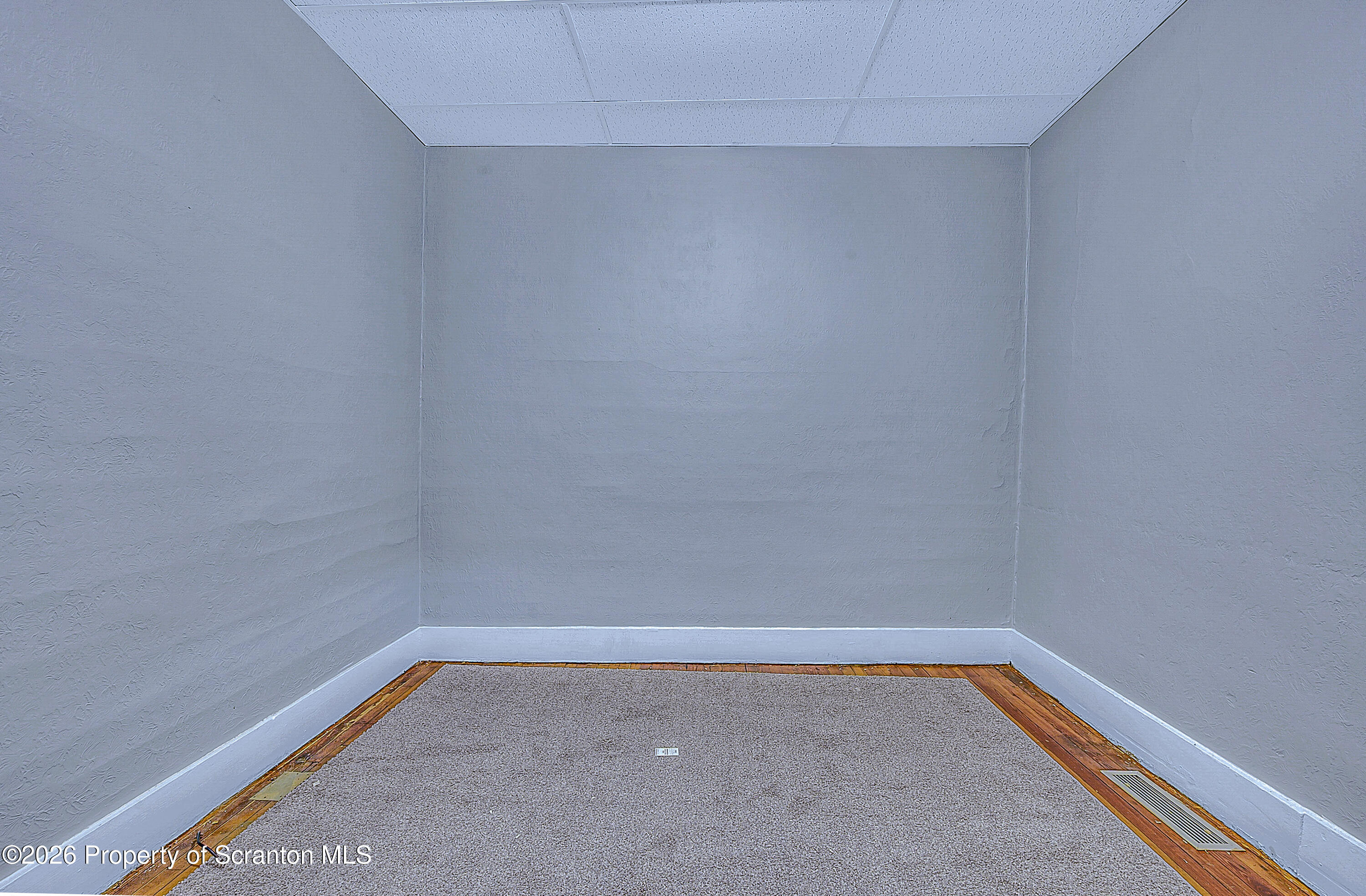 714 Smith Street Dunmore, PA 18512 - Photo 9 of 15 a empty room with a bench