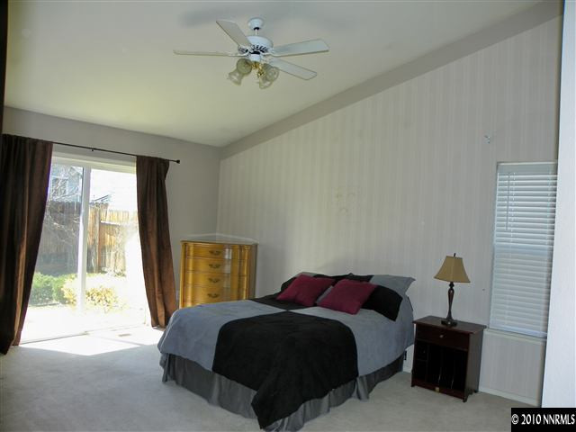 5860 Simons Drive Reno, NV 89523 - Photo 7 of 9 a bedroom with a bed and a window