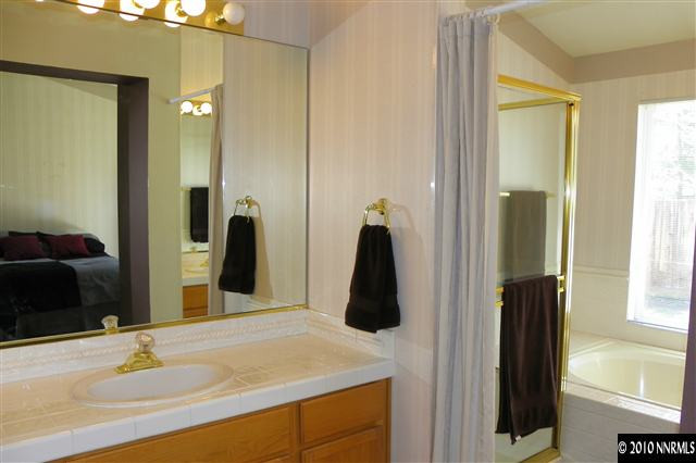 5860 Simons Drive Reno, NV 89523 - Photo 8 of 9 a bathroom with a sink and a mirror