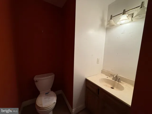 a bathroom with a sink toilet and mirror