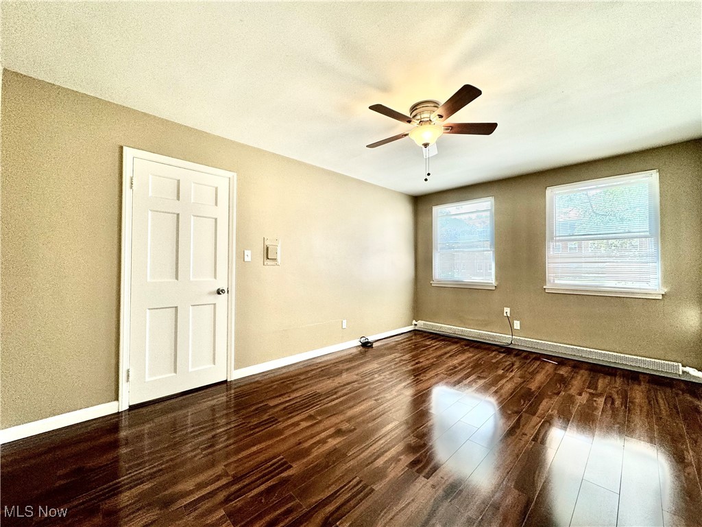 13805 Cedar Road, Unit 103C Cleveland, OH 44118 - Photo 10 of 18 Bedroom featuring dark wood-style flooring, ceiling fan, and a textured ceiling