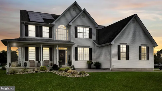 a front view of a house with garden and porch