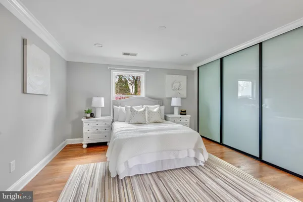 a bedroom with a bed window and table chair