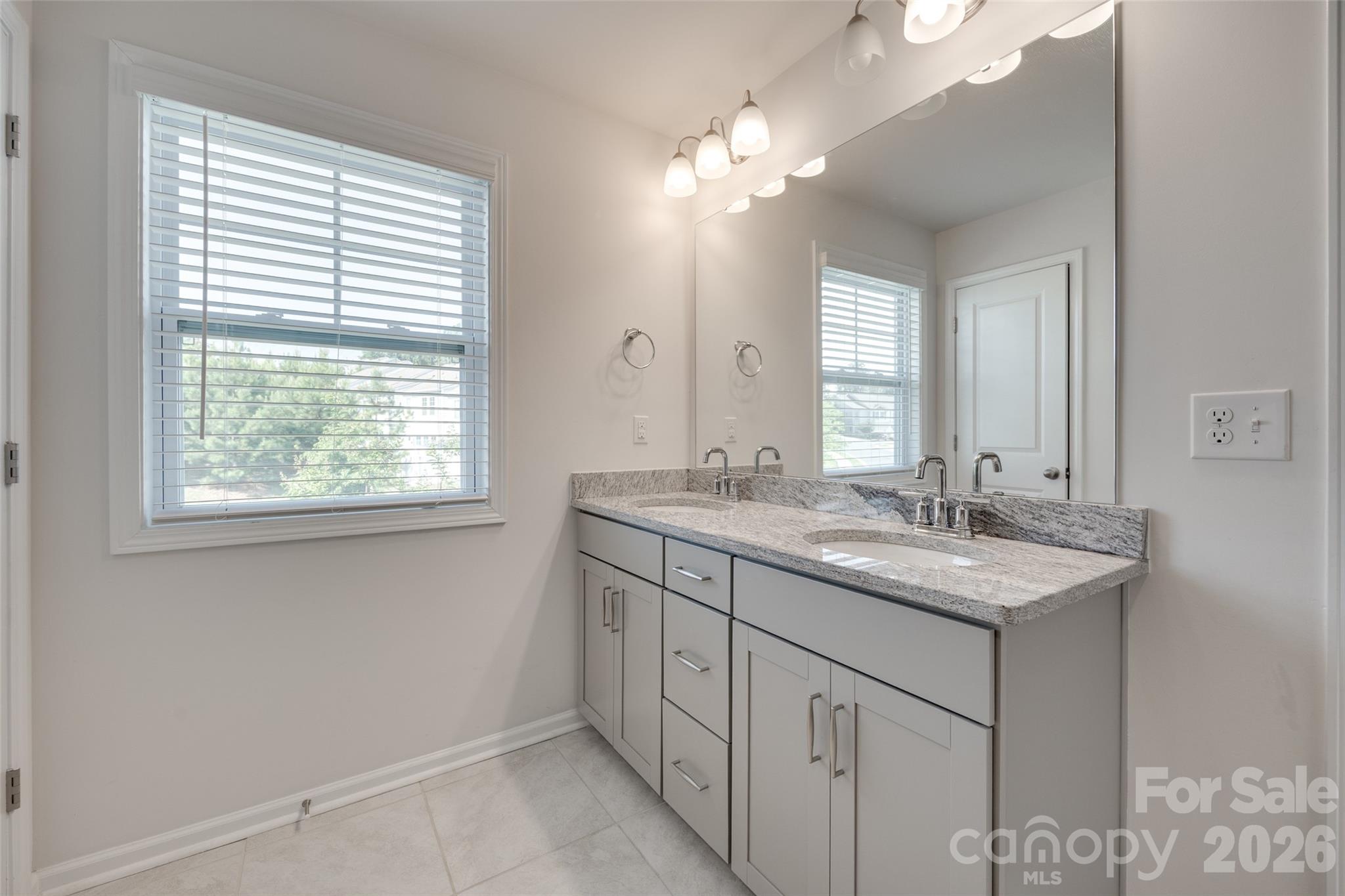 642 Altamonte Drive Clover, SC 29710 - Photo 28 of 41 a bathroom with a granite countertop sink a large mirror and a window