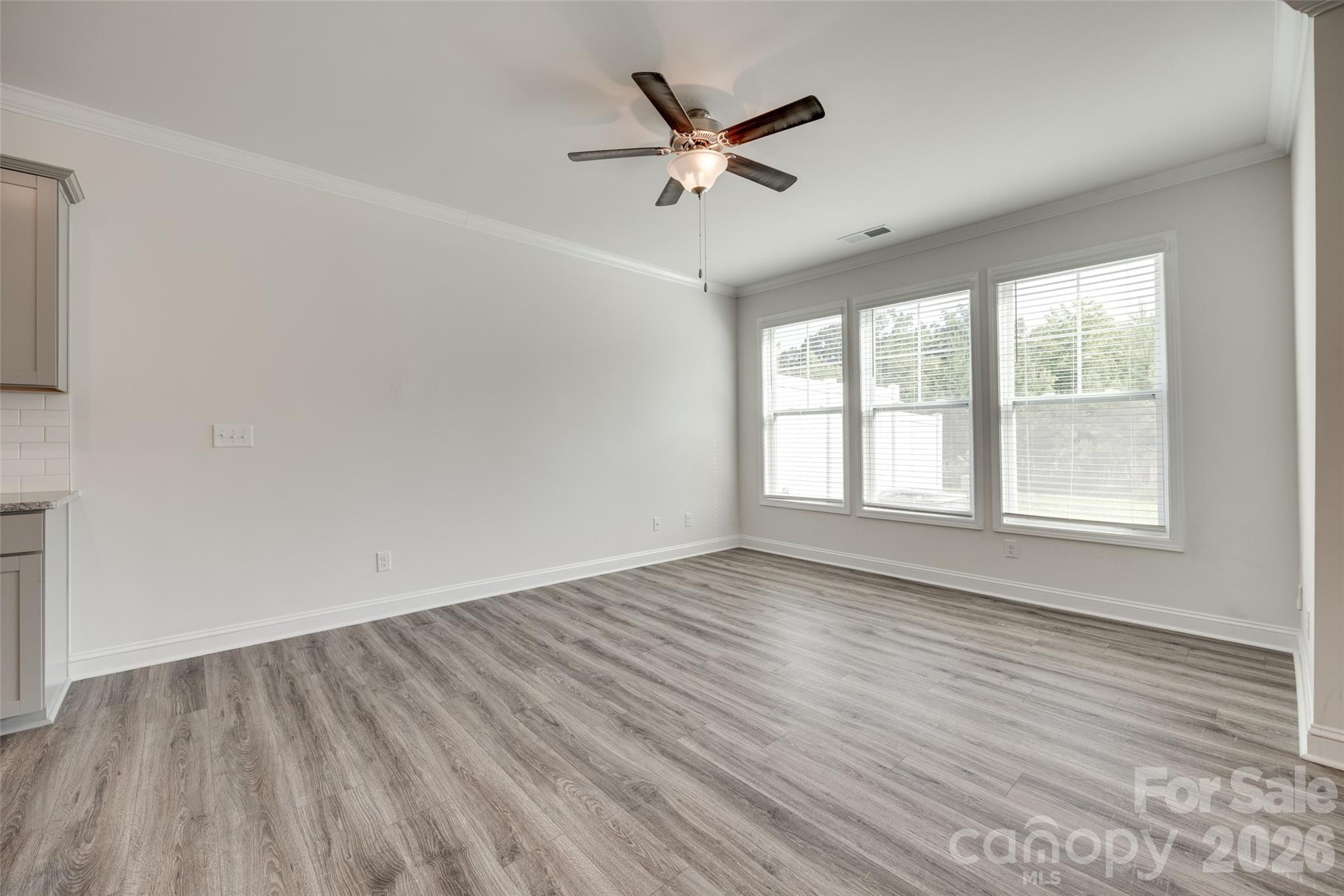 642 Altamonte Drive Clover, SC 29710 - Photo 3 of 41 an empty room with wooden floor fan and windows