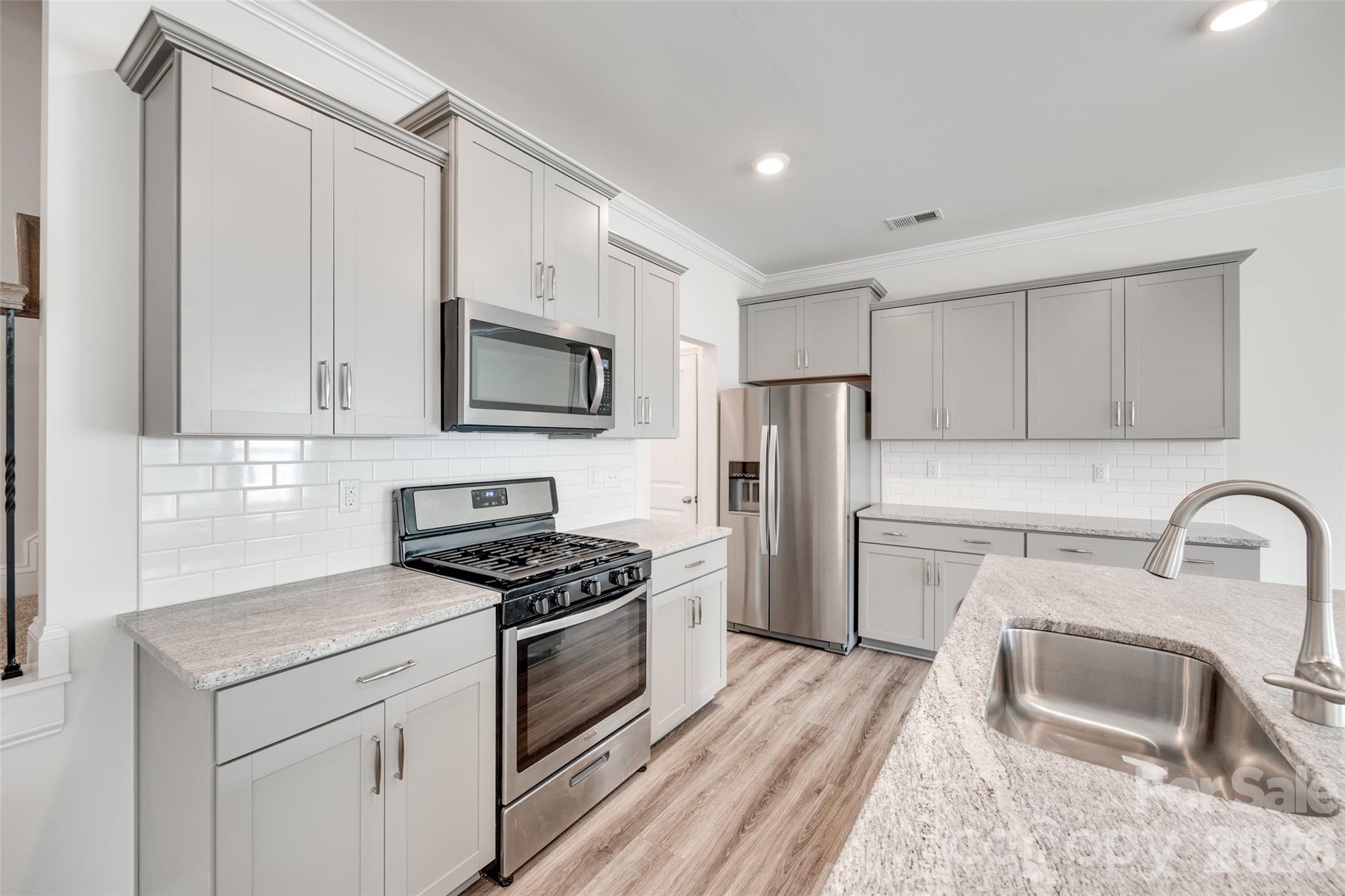 642 Altamonte Drive Clover, SC 29710 - Photo 10 of 41 a kitchen with refrigerator a microwave a sink and cabinets